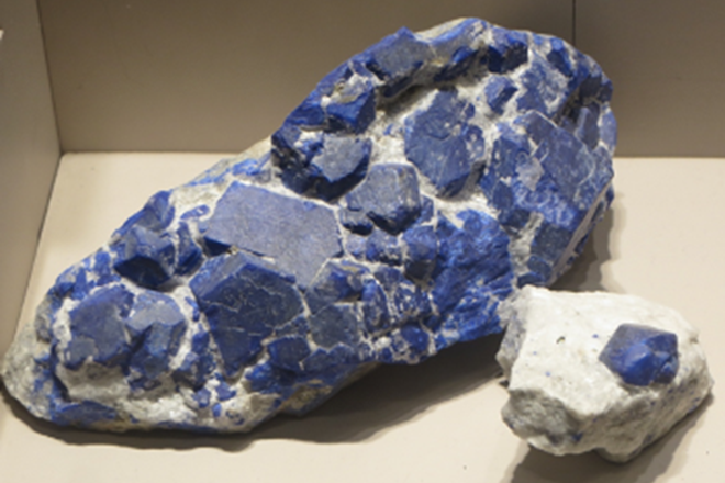 A big rock with pieces of Lapis Lazuli embedded in it.